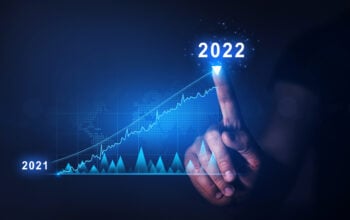 Businessman draws  increase arrow graph corporate future growth year 2021 to 2022.   Planning,opportunity, challenge and business strategy. New Goals, Plans and Visions for Next Year 2022